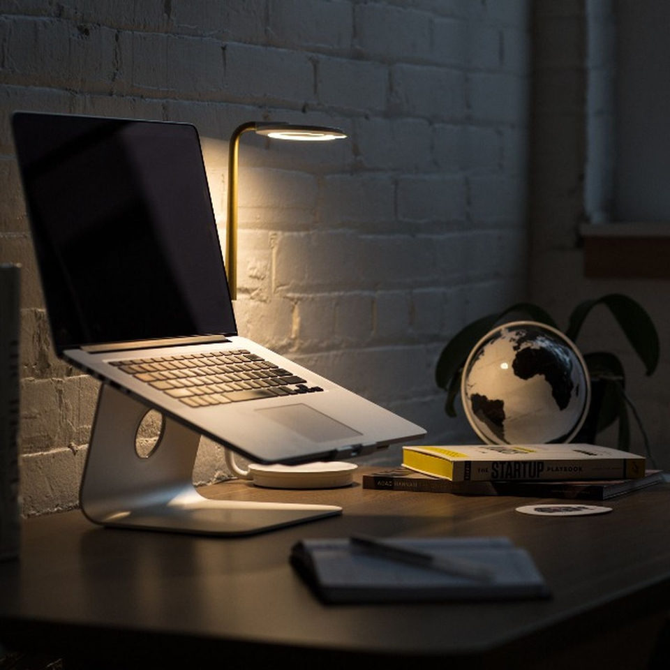 A laptop raised on an aluminium stand
